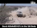 Stock HUMMER H3s take on the silt beds of Baja 