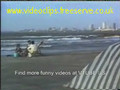 Guy Falls over and lands head first in womans butt on beach FUNNY