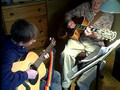 Aaron playing guitar with his teacher
