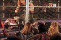 female wrestler gi ho jumps from top of steel cage