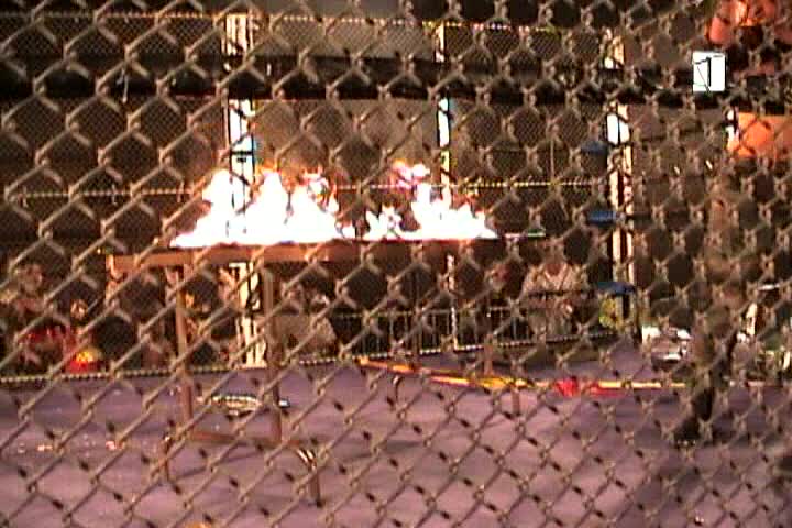 Flaming table inside a steel cage with GI HO!