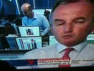Banker caught on TV looking at topless girls instead of charts