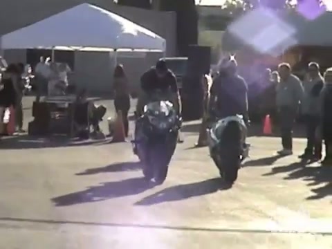 Motorbike Wheelie Nails Bystanders