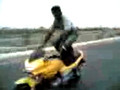 Street racers-dude standing on a bike at 60kmph